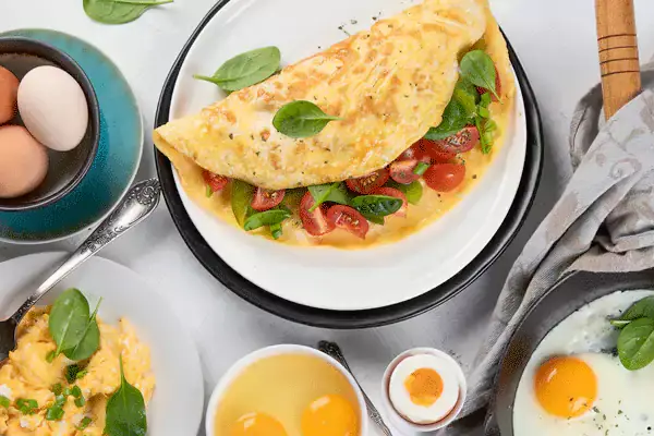 Omelette and eggs served with fresh salad