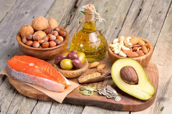 Healthy fats including salmon, avocado, nuts and olive oil