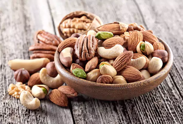 Assorted nuts and seeds on a wooden board