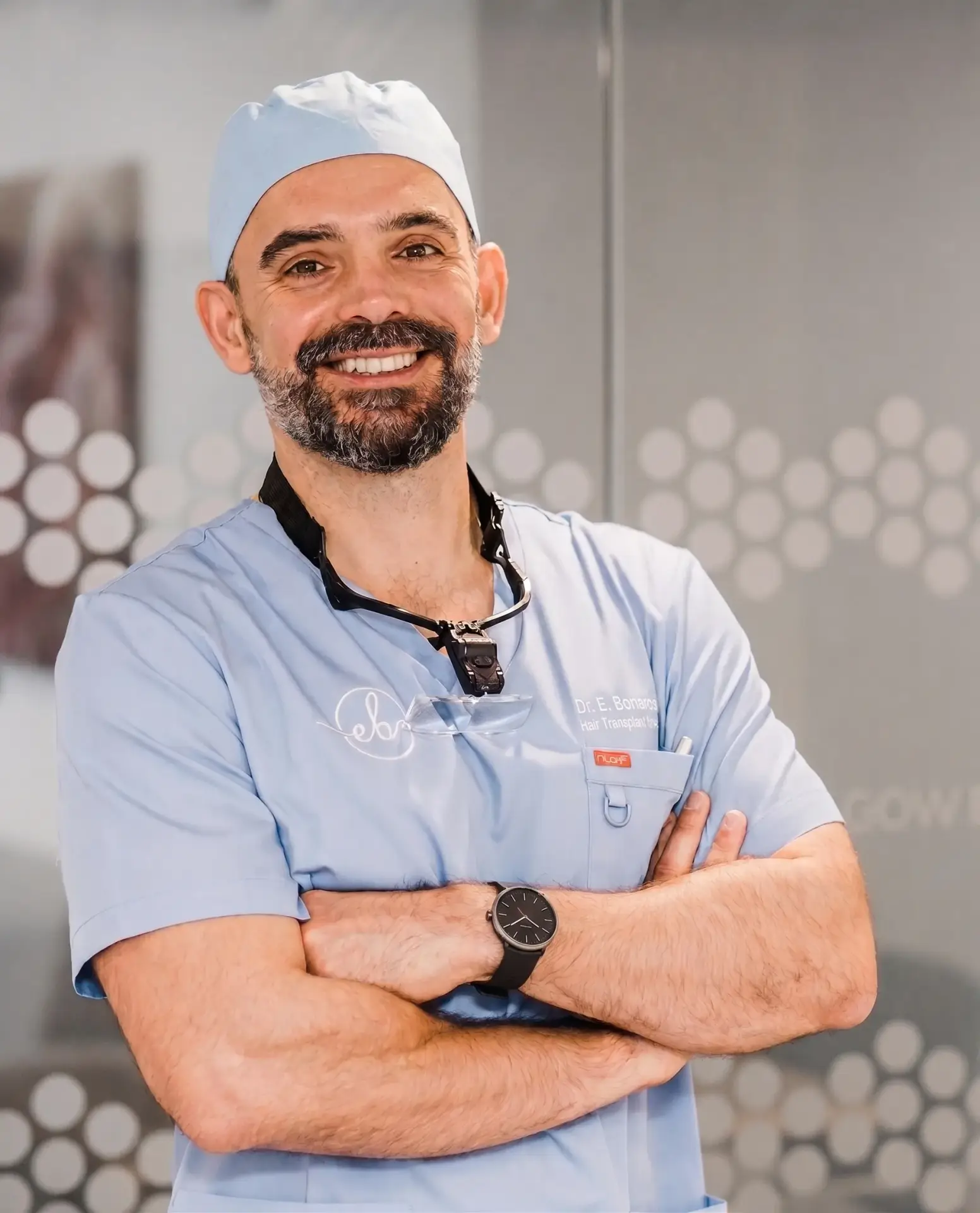 Dr Epameinondas Bonaros in scrubs with his arms folded at the Glasgow clinic